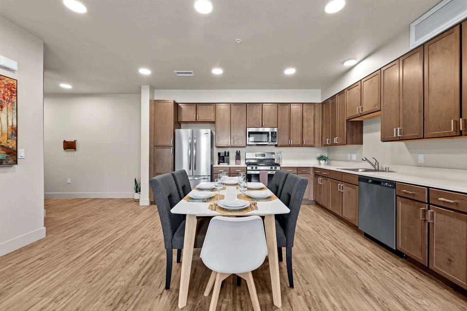 A full-size dining table set for six, right off the chef-ready kitchen.