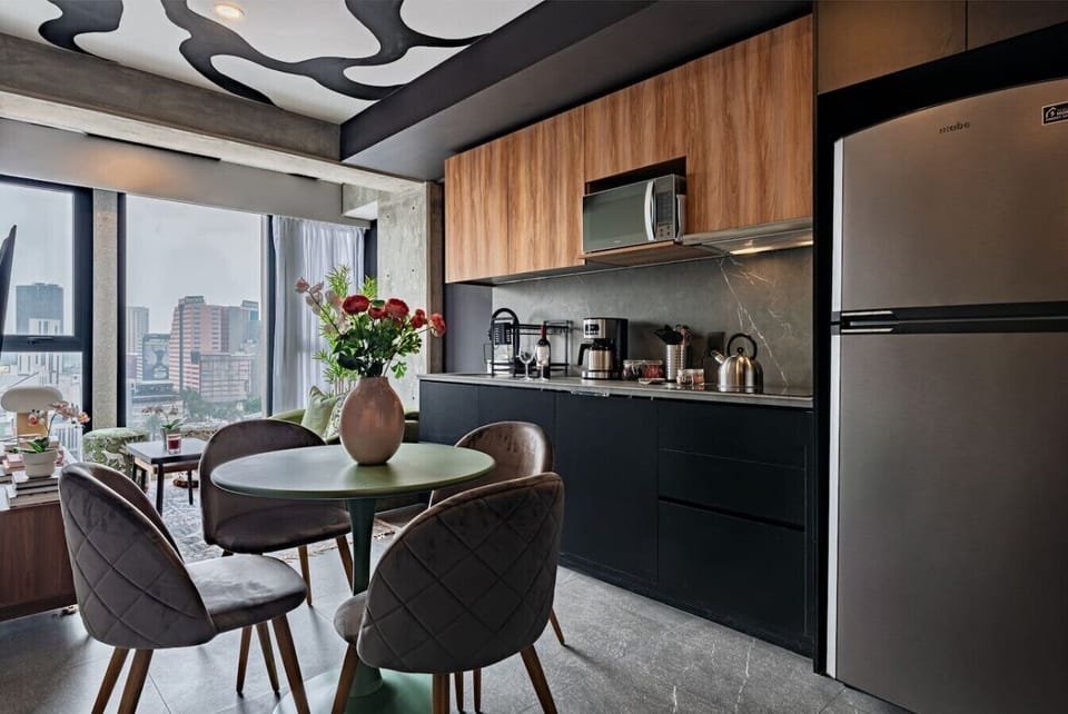 Prepare meals with ease in the modern kitchen, with quality appliances, and a stylish dining area.