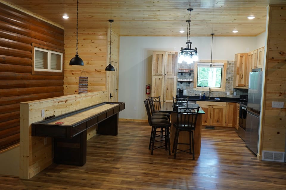 Shuffleboard table. 6 bar stools for seating.
