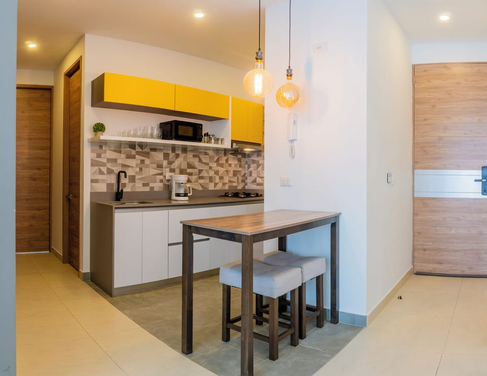 Deluxe Apartment, Balcony, Beach View | Private kitchen | Fridge, cookware/dishes/utensils, kitchen island