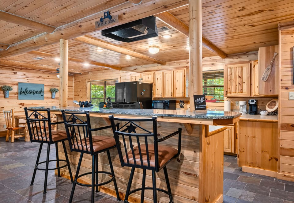 The spacious kitchen offers plenty of room for preparing meals together while staying connected to the rest of the cabin's inviting gathering spaces.