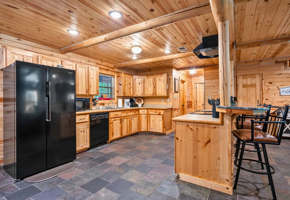 Modern appliances, generous counter space, and warm wood finishes make this kitchen both functional and welcoming for everything from quick breakfasts to family dinners.