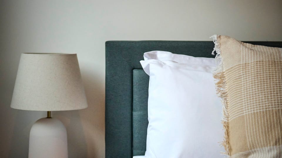 Soft textures and thoughtful styling bring warmth and comfort to the bedroom.