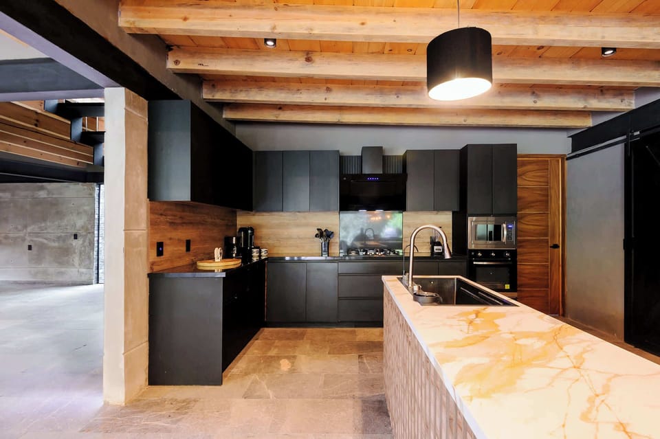 Espresso and coffee stations sit ready beside the gas cooktop's live-fire burners