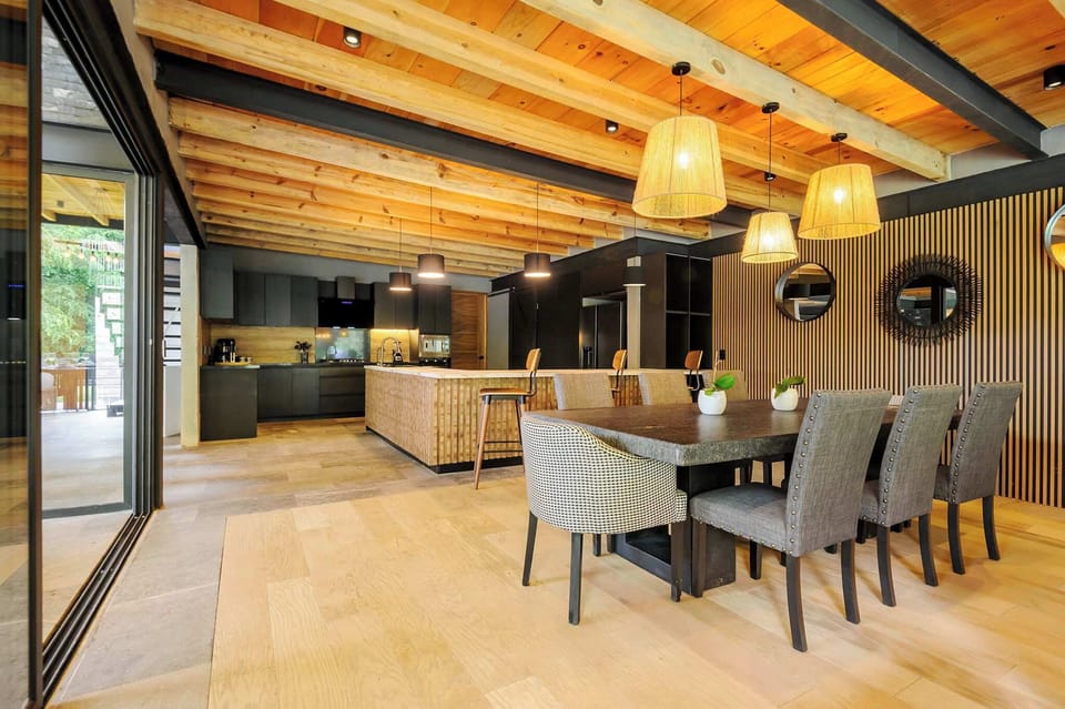 An open-plan dining and lounge space flows seamlessly toward the fully equipped kitchen beyond.