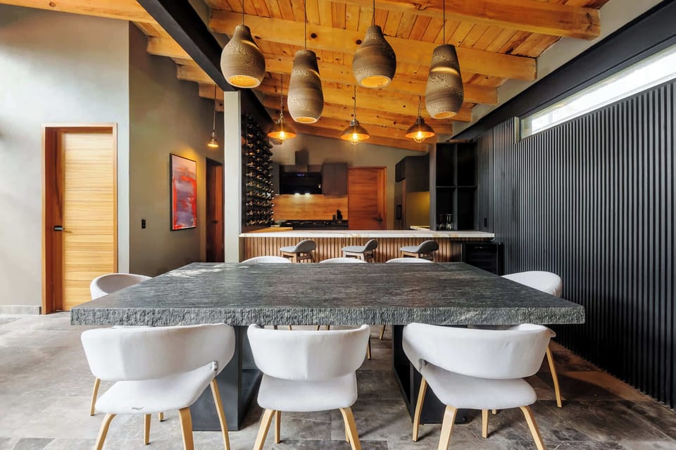 Warm cedar ceilings and industrial pendants set an elegant tone for group dinners.