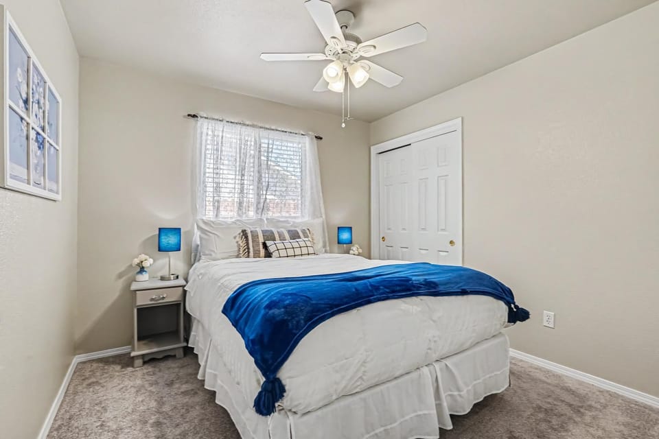 The front bedroom features a comfortable full-size bed with a peaceful white and blue décor. The calming design creates a relaxing atmosphere, making it a cozy space to unwind and enjoy a restful night's sleep.