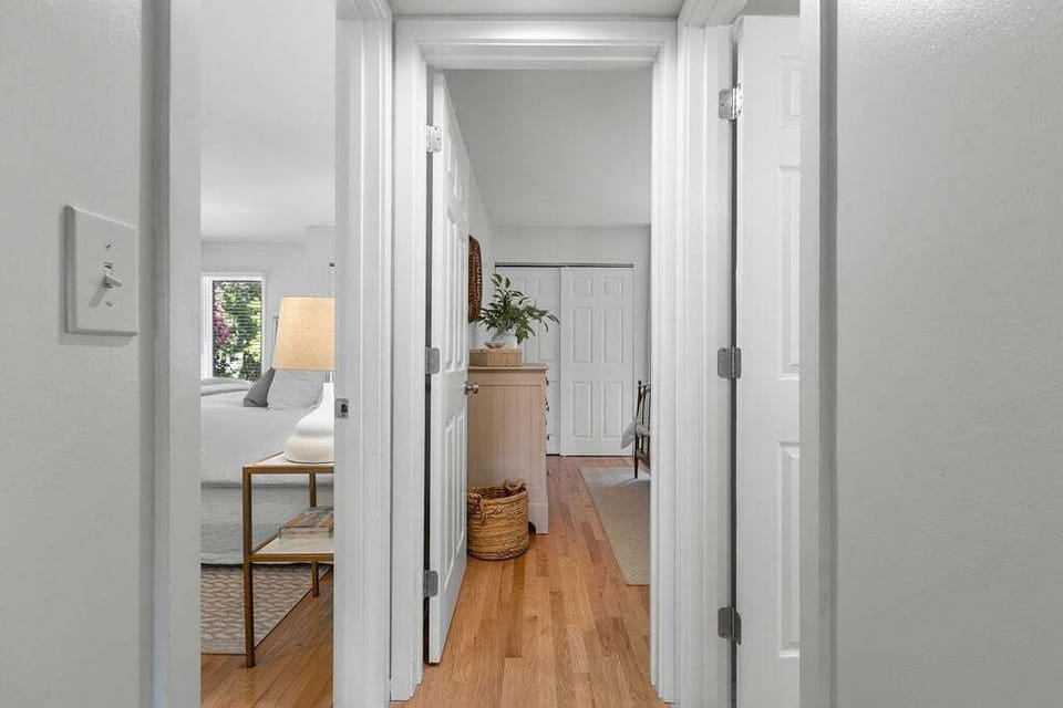 Hallway leads to private primary and guest suites.