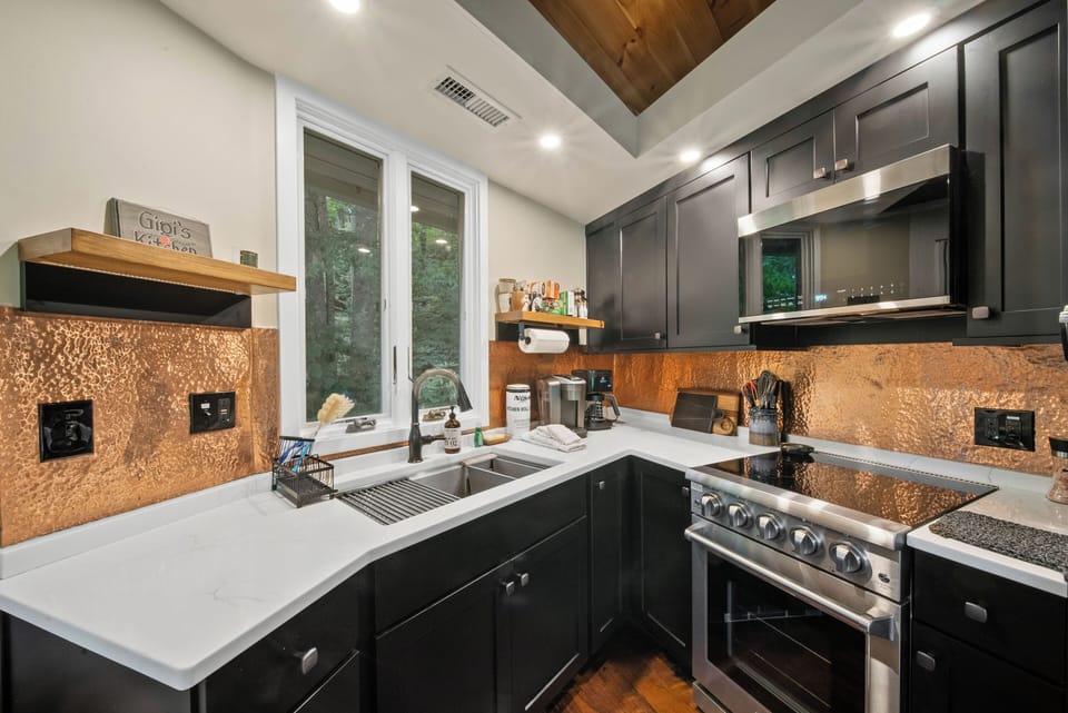 Stainless Appliances, Ceramic Cook Top, and Beautiful Copper Backsplash