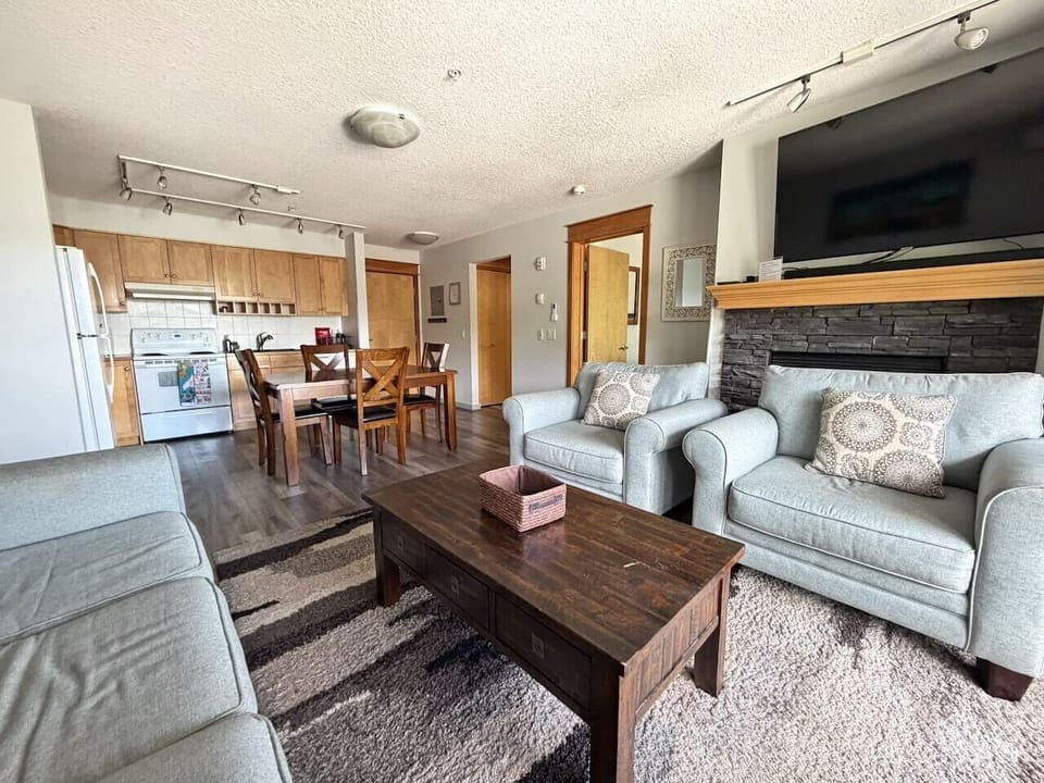 Large living area with plenty of comfortable seating with large flat screen TV