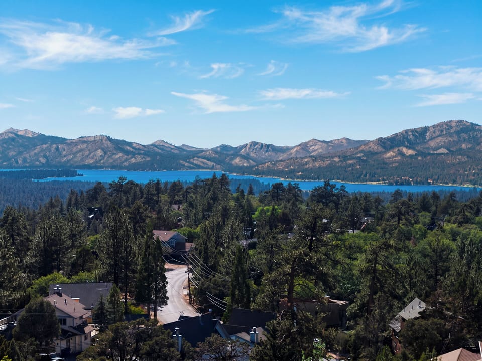 Distance aerial view showing the property's close proximity to the nearby pristine blue lake.