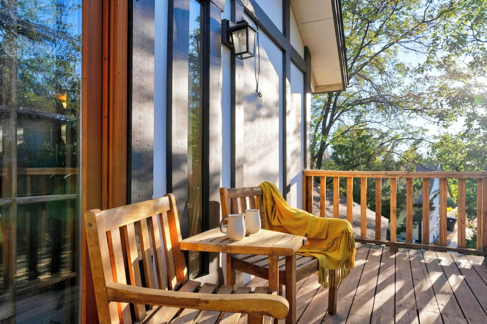 Intimate deck seating nook framed by beautiful mature trees.