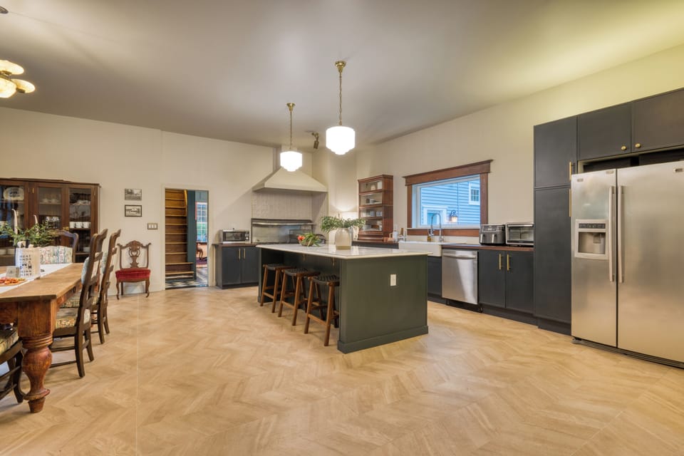 Chef-ready kitchen with an oversized island, bar seating, and a beautiful blend of modern updates and historic charm.