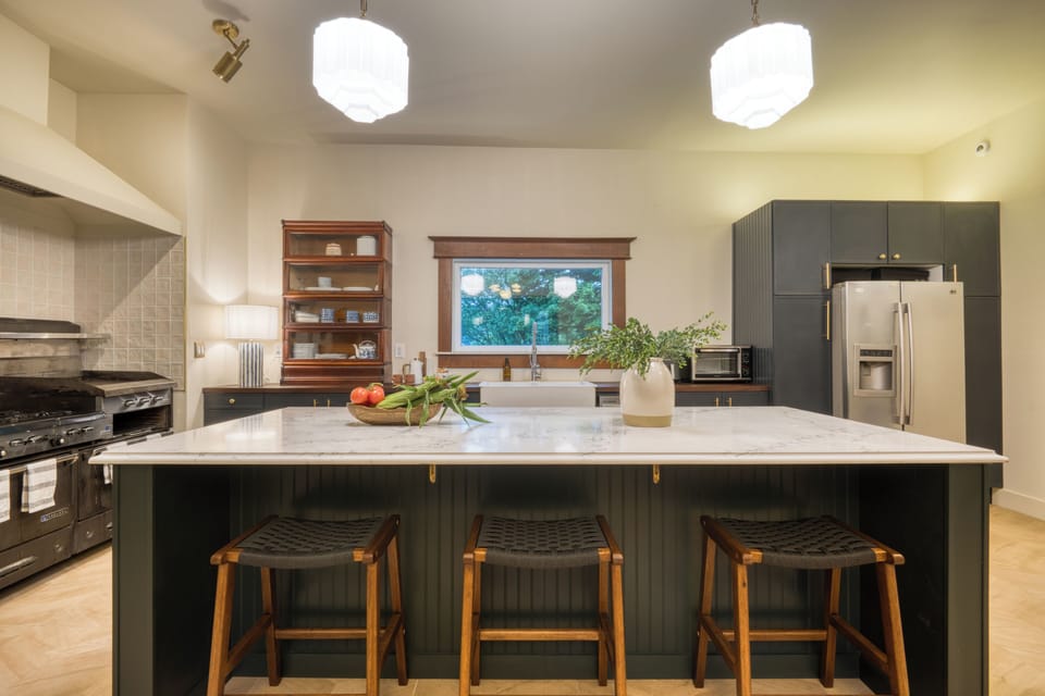 Chef-ready kitchen with an oversized island, bar seating, and a beautiful blend of modern updates and historic charm.