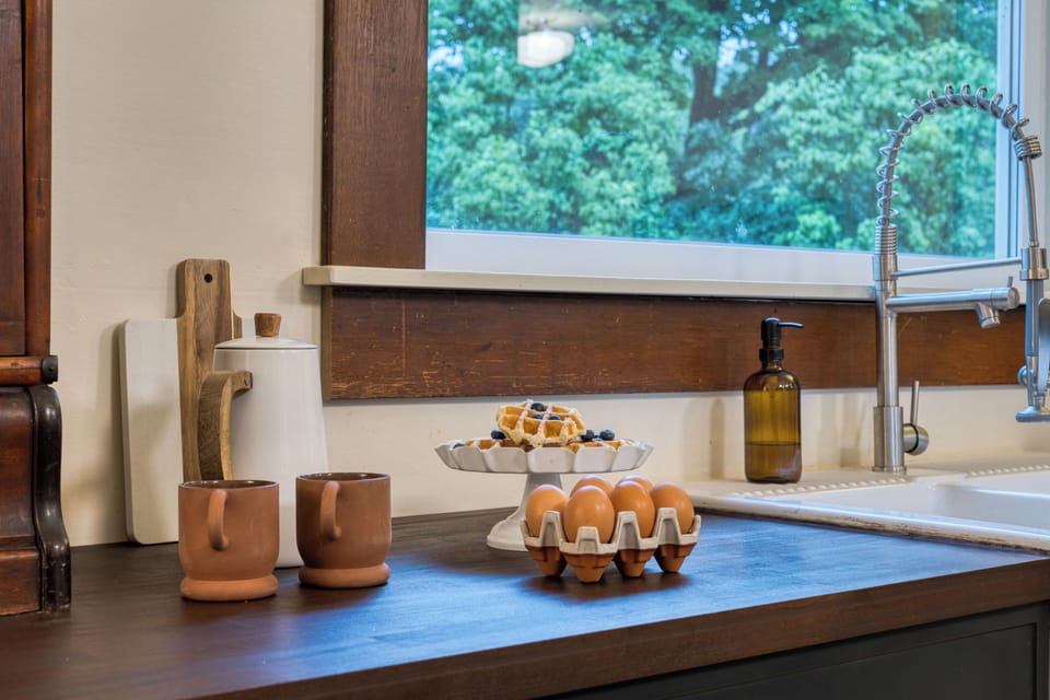 Chef-ready kitchen with an oversized island, bar seating, and a beautiful blend of modern updates and historic charm.
