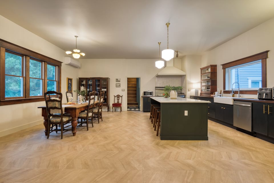 Spacious kitchen and dining area blending modern updates with historic woodwork and antique details.