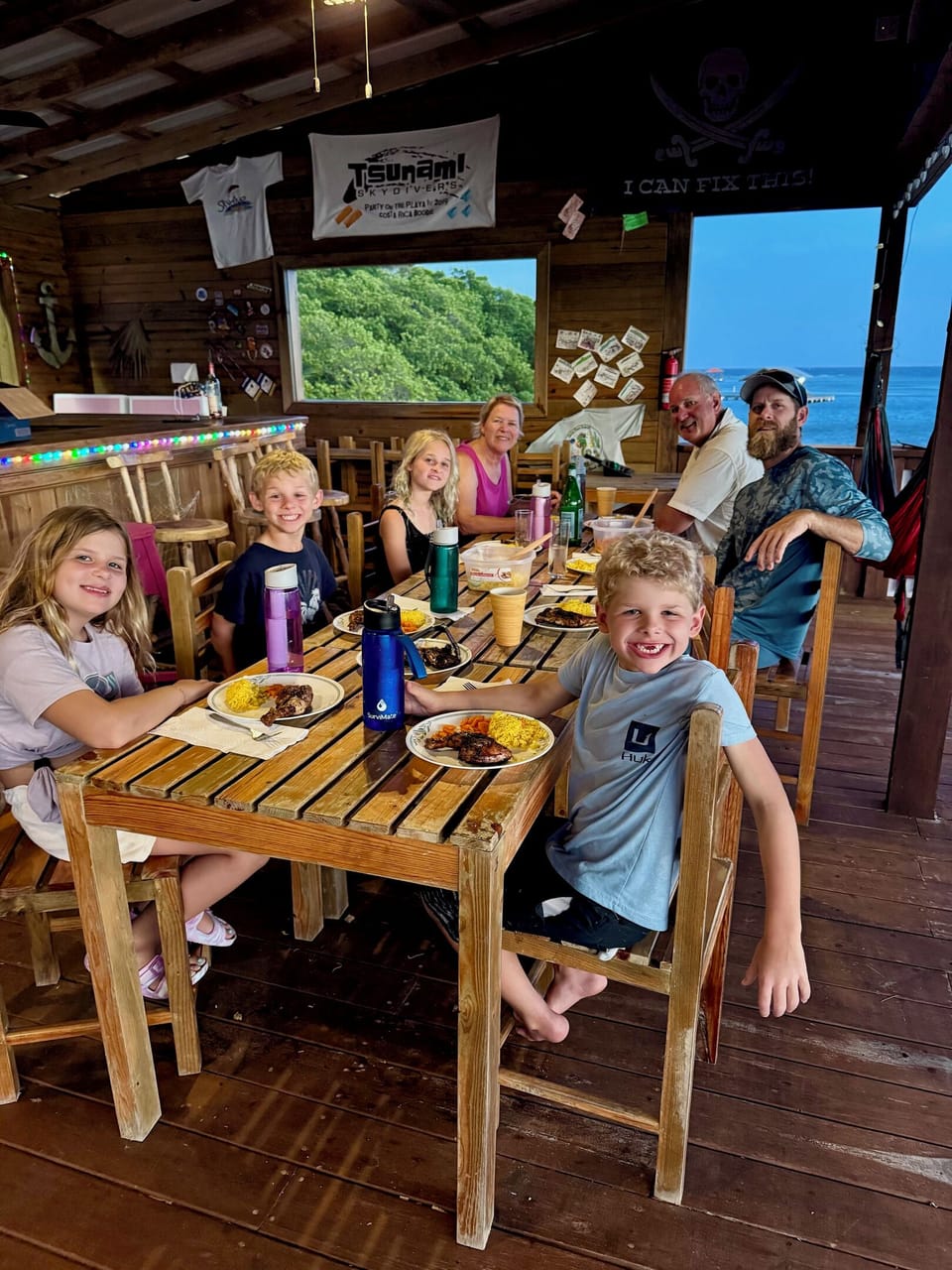 Guest and family having dinner over the bay in La Rosa.