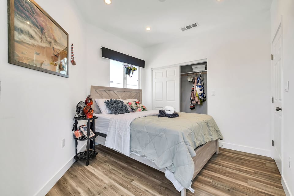 Queen bed with calm decor and natural light