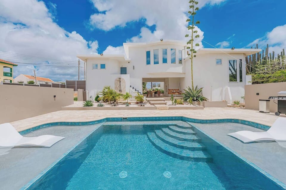 Enjoy sunny pool days surrounded by modern architecture, tropical landscaping, and plenty of open space.
