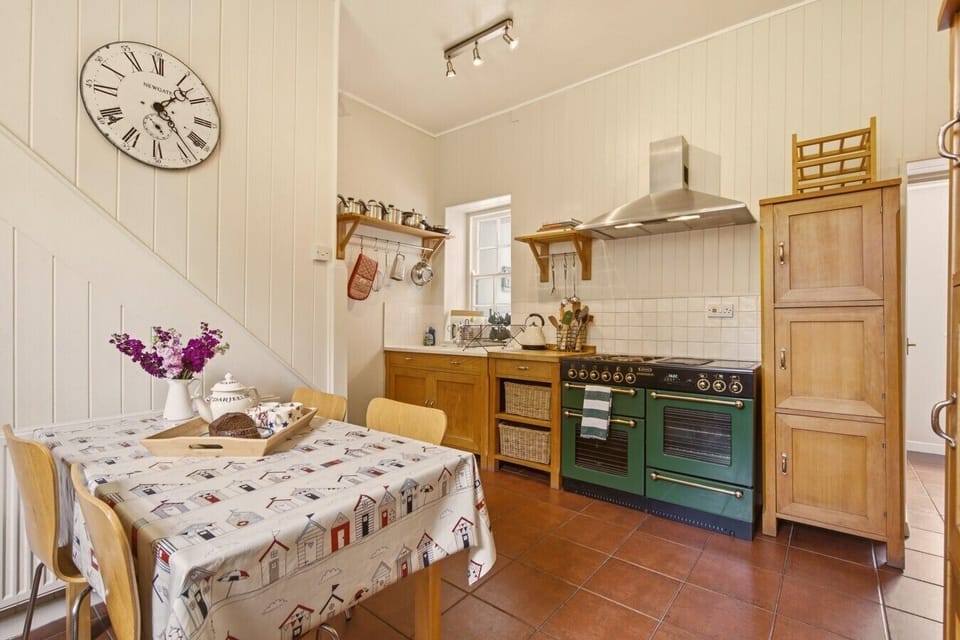 Traditional farmhouse kitchen with breakfast table and classic range cooker