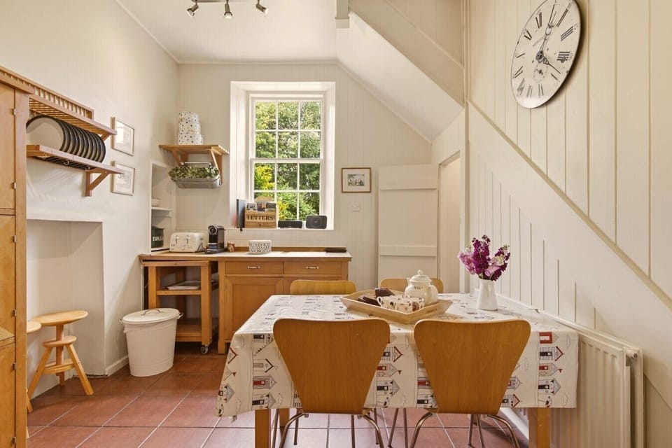 Bright farmhouse kitchen with breakfast table and large sash window