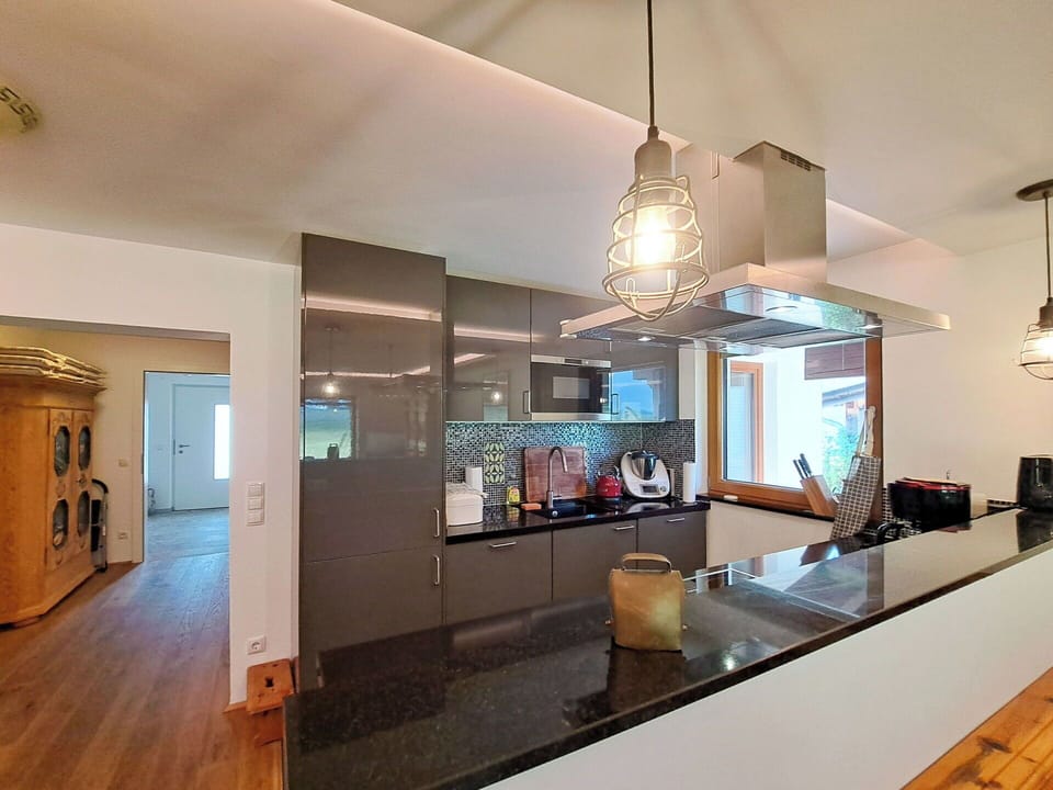 Furniture, Interior Design, Kitchen, Countertop, Flooring, Light Fixture, Wall, Ceiling, Wood, Cabinetry
