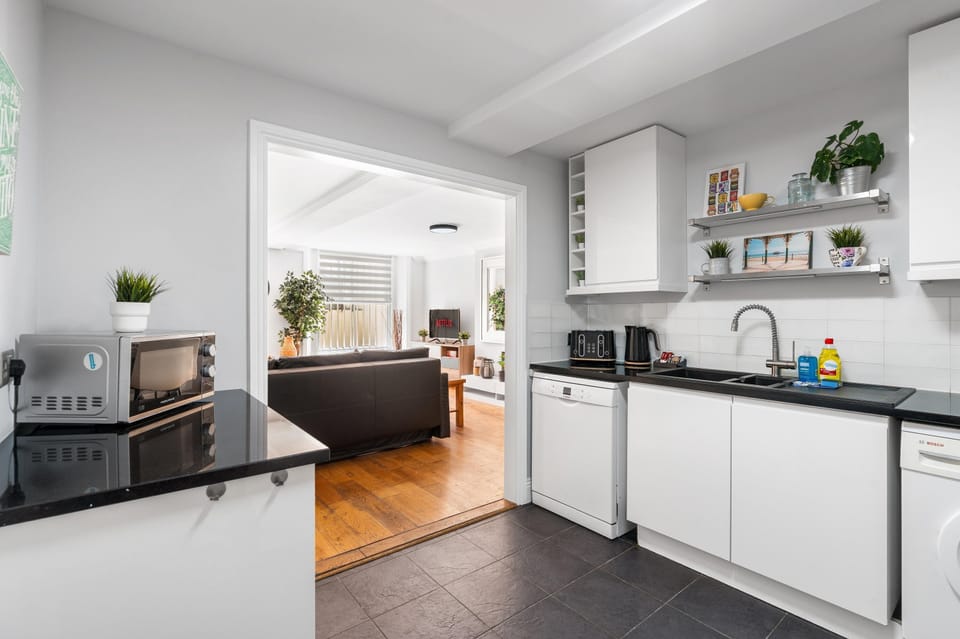 Fully equipped modern kitchen with dining space, perfect for preparing family meals and enjoying breakfast together
