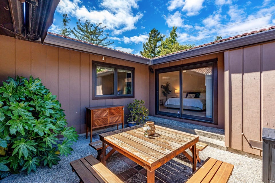 Your private courtyard oasis, framed by blue skies and greenery—perfect for morning coffee or unwinding under the stars with the bedroom just steps away.