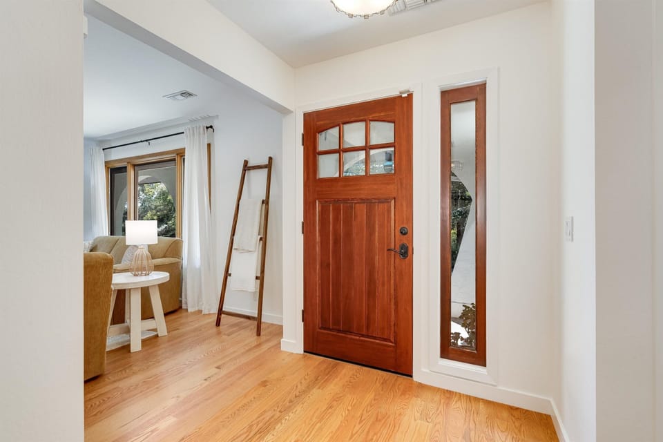 Step inside to warm wood accents and an open, sun-filled entryway that flows effortlessly into the living space—your welcoming retreat after a day of adventure.