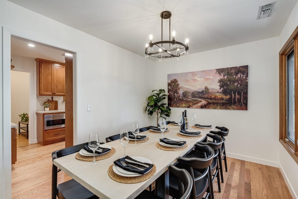 Gather everyone around this spacious dining table for memorable meals together. The elegant fixture and warm wood tones create a welcoming atmosphere perfect for sharing stories over dinner.