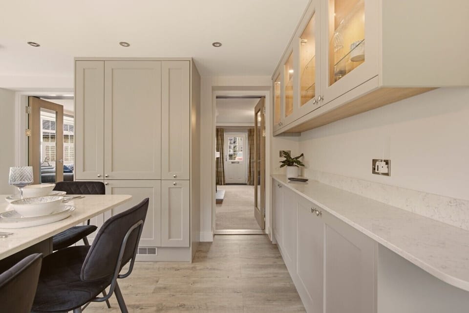 Elegant dining area with bespoke cabinetry and generous quartz worktops