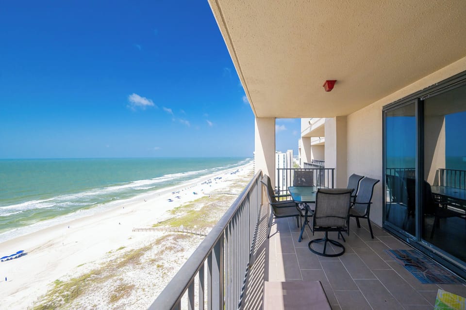 Enjoy your balcony retreat with rhythmic coastal sounds and endless blue stretching beyond the shore