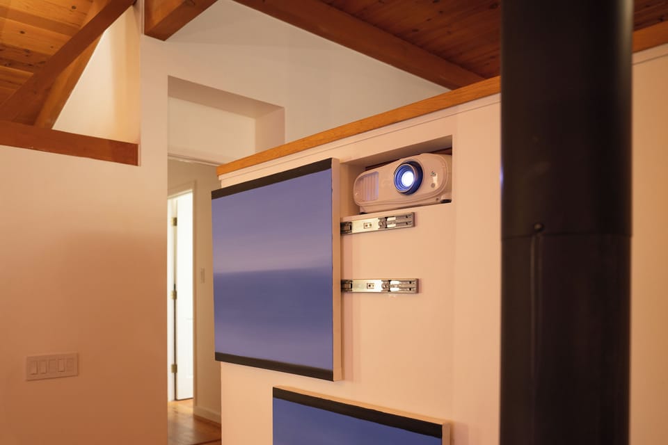 Cozy movie nights await with your own private projector setup beneath warm wood beam ceilings, creating the perfect ambiance for unwinding after exploring.