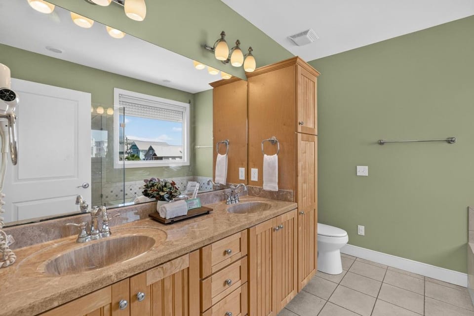 2nd floor, Bathroom 1: the king suite`s ensuite, with double sinks, a glass walk-in shower and a soaker tub, so no waiting your turn