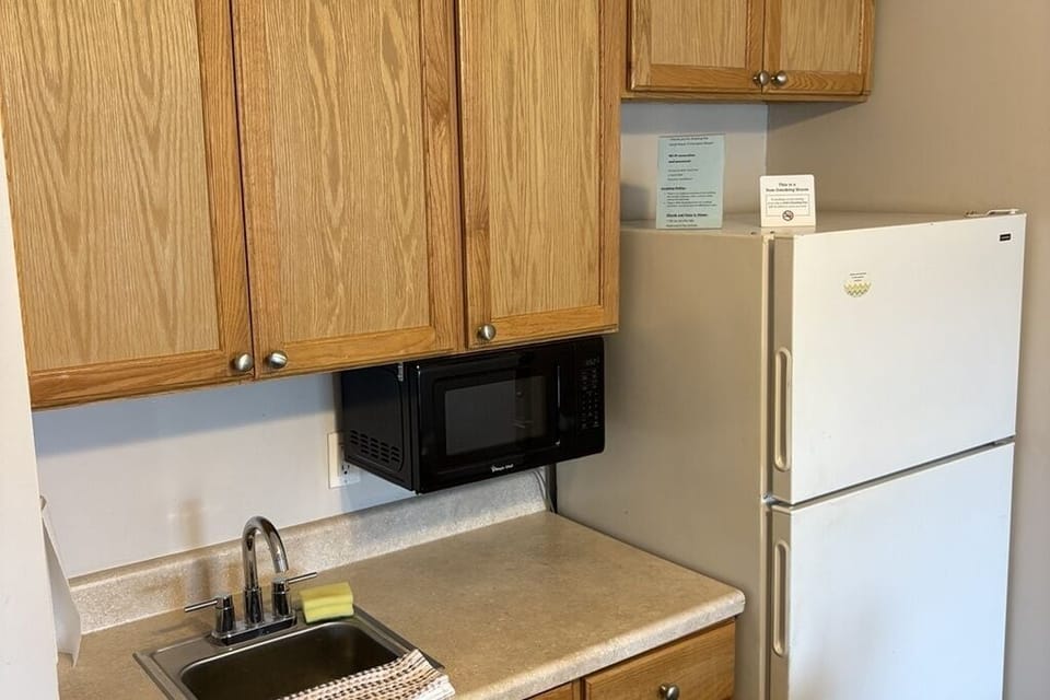 Full-size fridge, microwave, cookware/dishes/utensils