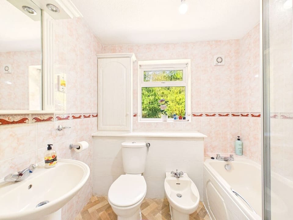 Bright bathroom with both a bathtub and separate shower for your comfort.