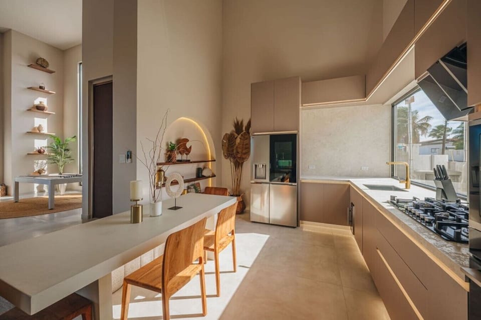 Kitchen is surrounded by warm, elegant details and plenty of natural light.
