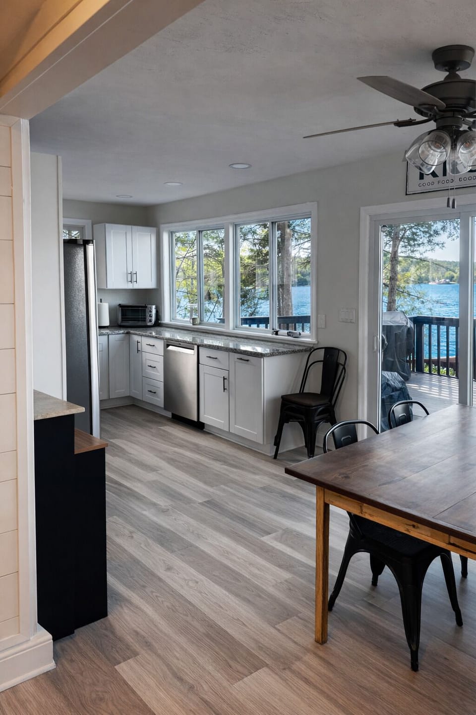 Open kitchen and dining area with lake views and stainless appliances.