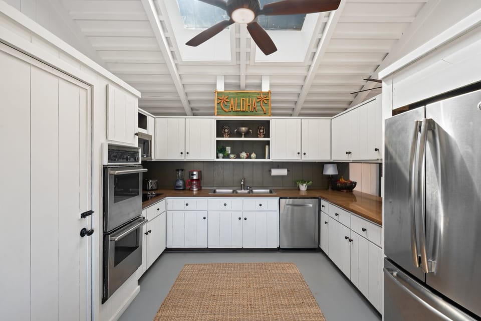 Fully equipped kitchen featuring stainless steel appliances, ample counter space, and everything needed to prepare meals at home.