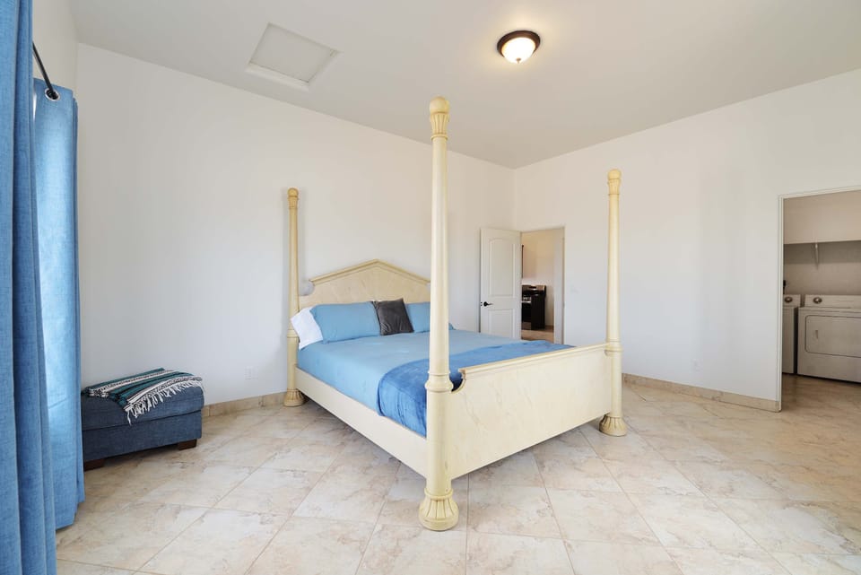 The bedroom at Dave's Place features a custom king-sized bed. This room also has a washer and dryer in the closet.