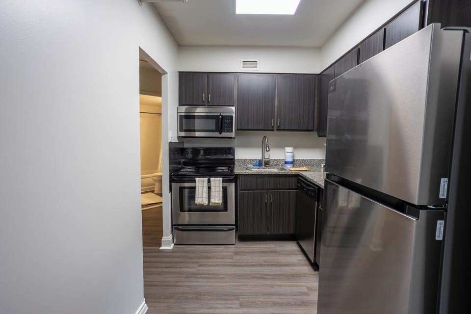 Modern kitchen with stainless appliances and bright skylight