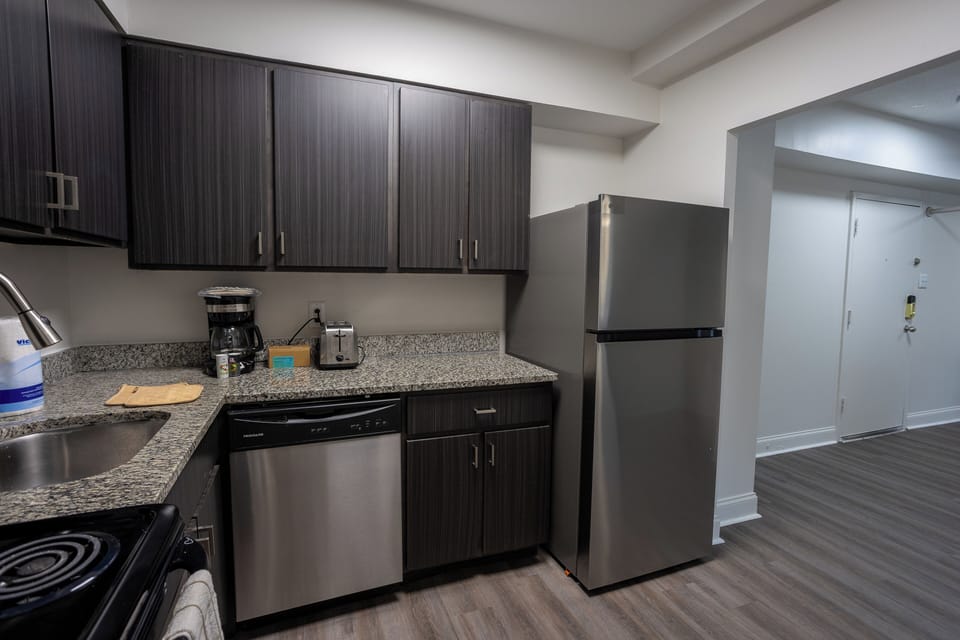 Modern kitchen with stainless appliances and coffee-ready counter space