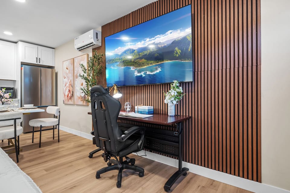 Dedicated workspace with a desk and TV for work or entertainment.