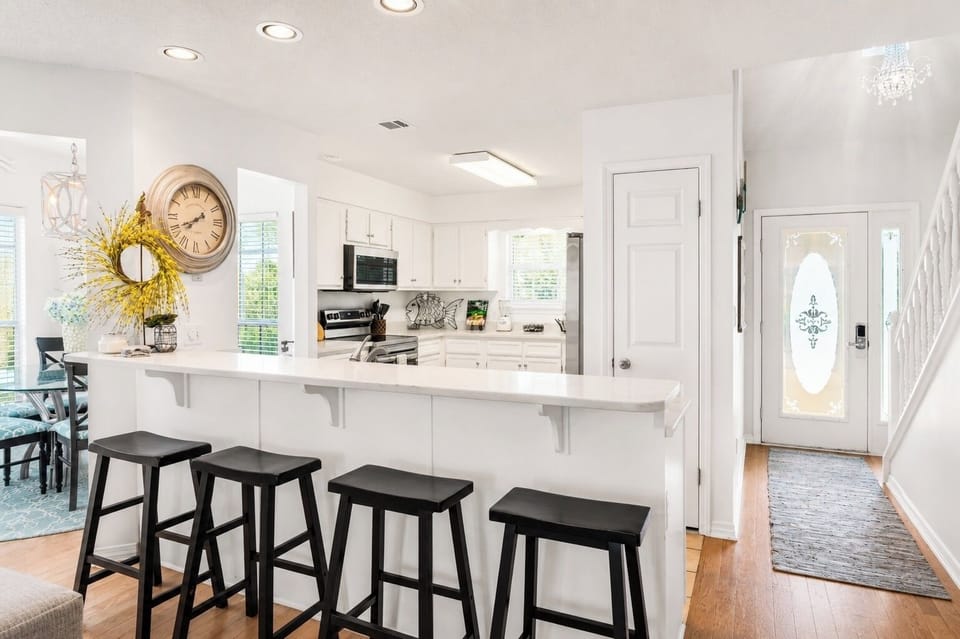 Coastal farmhouse entry and kitchen scene