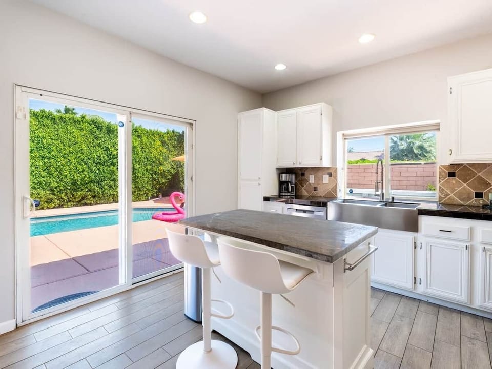 Fully stocked kitchen with direct access to pool deck.