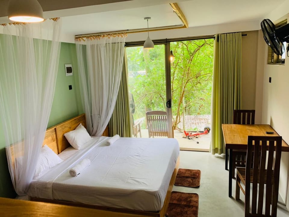 Deluxe Triple Room, Patio, Mountain View | In-room safe, blackout drapes, iron/ironing board (on request)