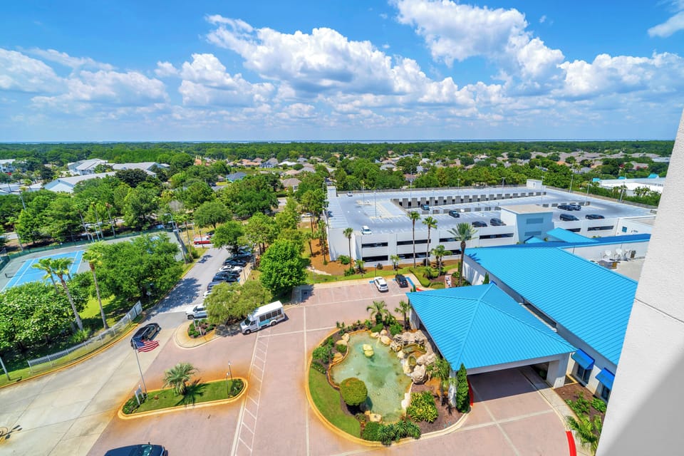 Tennis courts, parking garage, entrance to the lobby, and the free Palms of Destin Beach shuttle