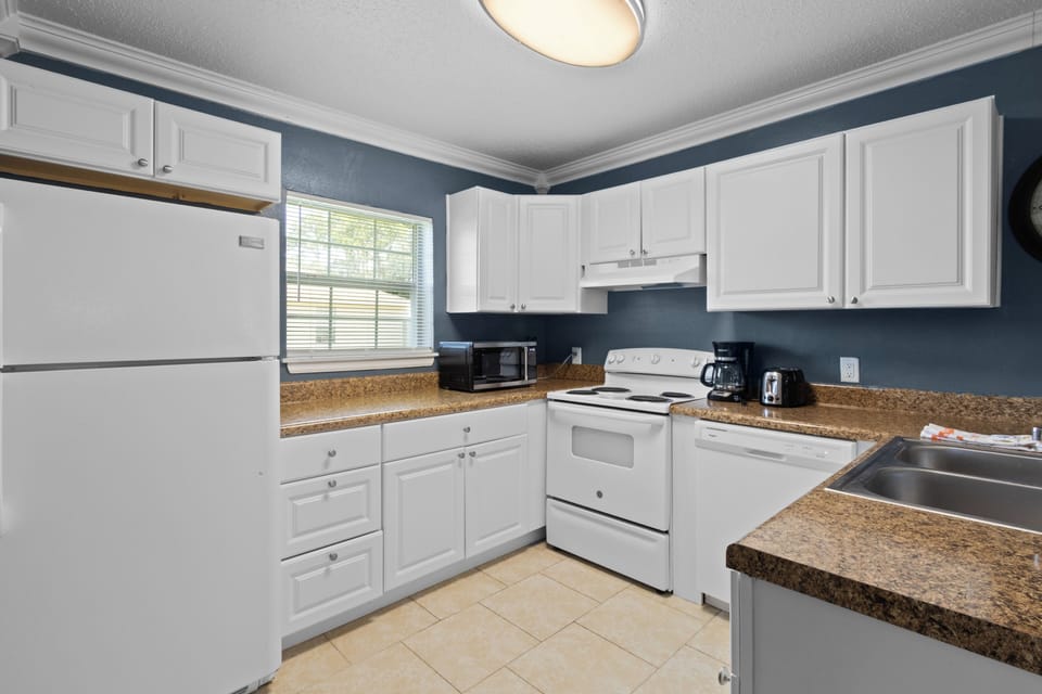 The bright and spacious full kitchen features a full-sized refrigerator, stove, oven, and microwave to handle all your culinary needs.