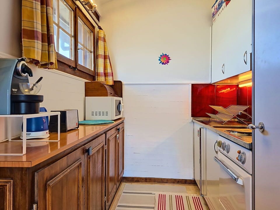 Wood, Interior Design, Flooring, Kitchen, Floor, Countertop, Room, Cabinetry, Major Appliance, Furniture