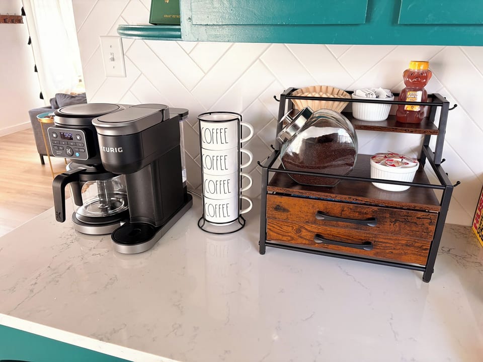 Bright, guest-ready coffee station with Keurig and organized drink essentials